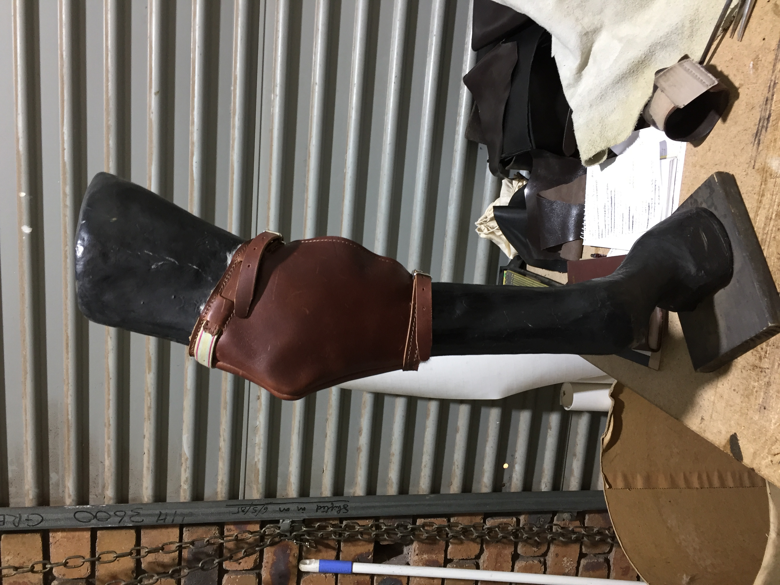 Custom leather knee brace on mannequin